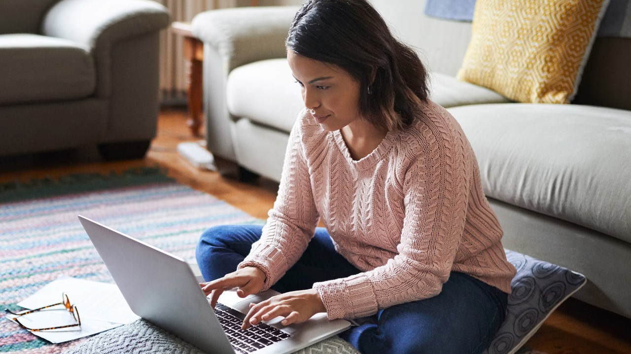 student sitting on floor and working on laptop; image used for HSBC International Services Study abroad article Finance tips for students.