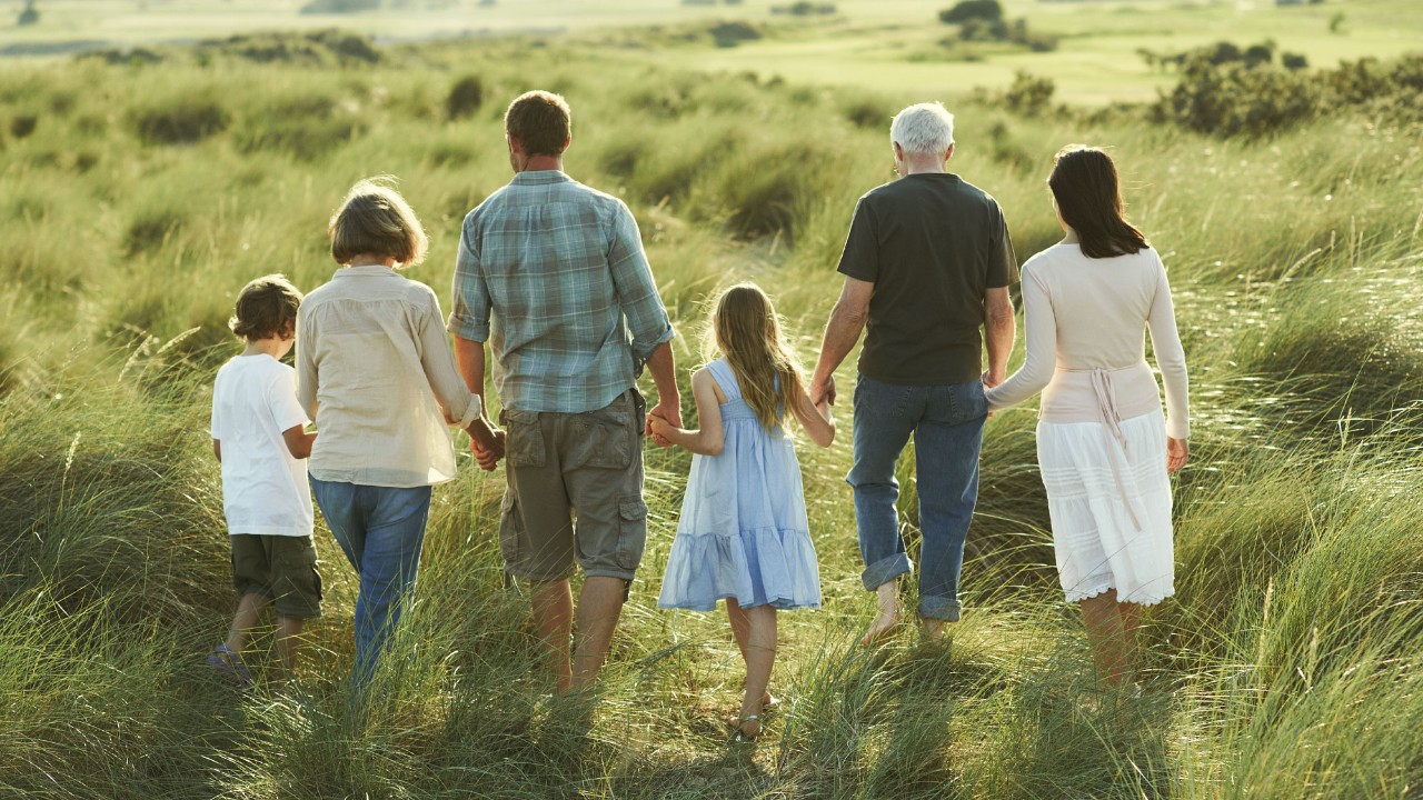 family walking on grass and holding hands; image used for HSBC International Services article 13 important questions to ask when creating your estate plan