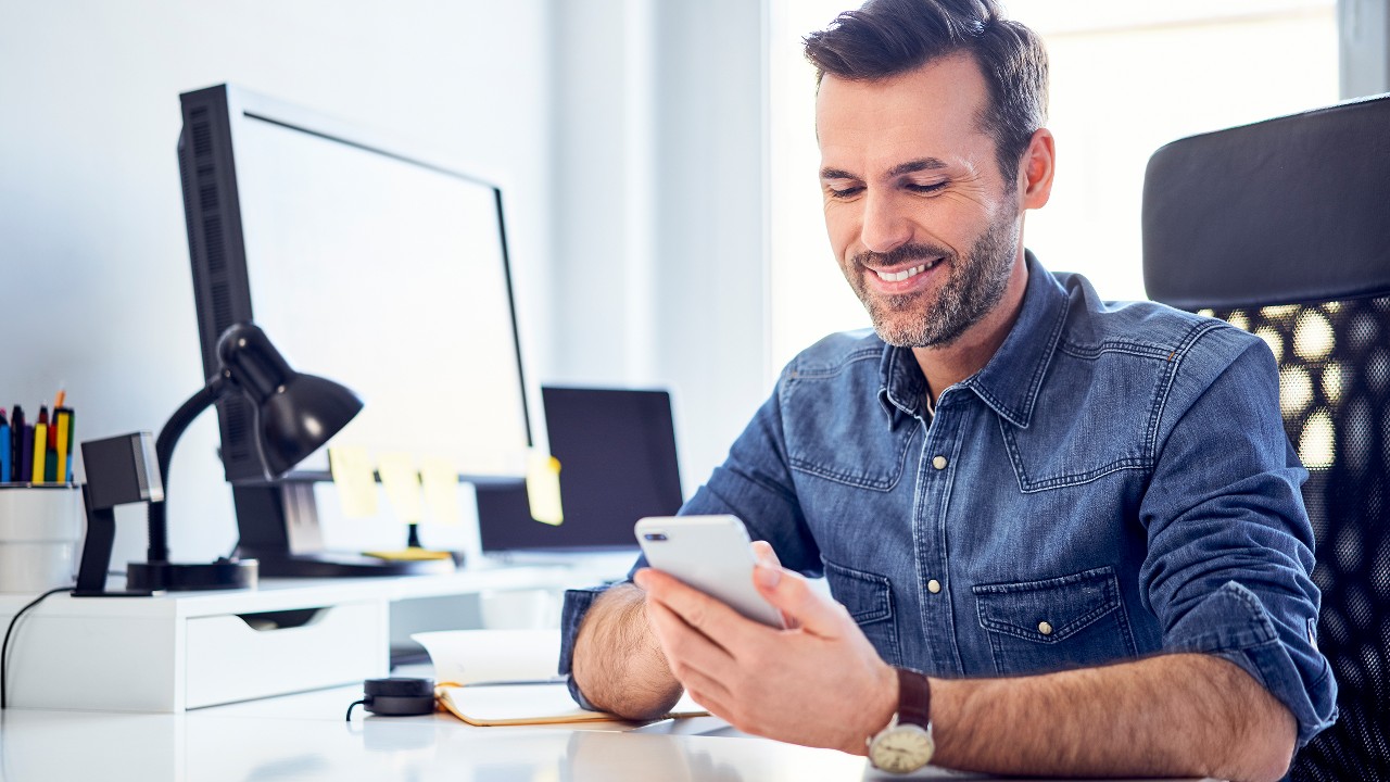 smiling man banking on mobile