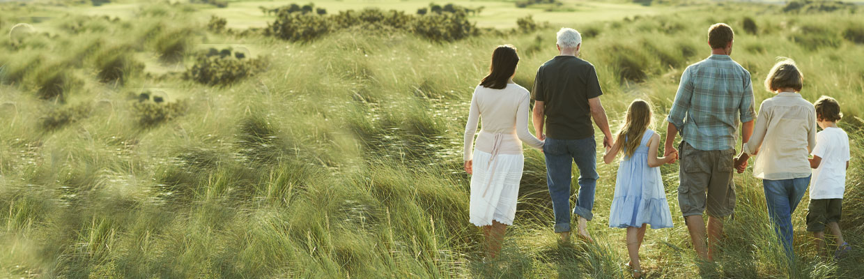 family walking on grass and holding hands; Image used for  HSBC International Services article 13 important questions to ask when creating your estate plan