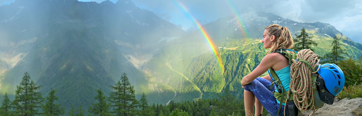 woman enjoying a colourful rainbow and mountain view; Image use for HSBC International Services Study abroad campaign Year of Opportunity.