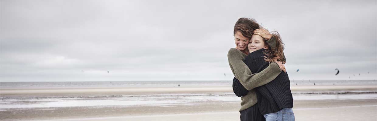 mum and daughter on beach hugging; image used for HSBC International Services study abroad article Support for parents.